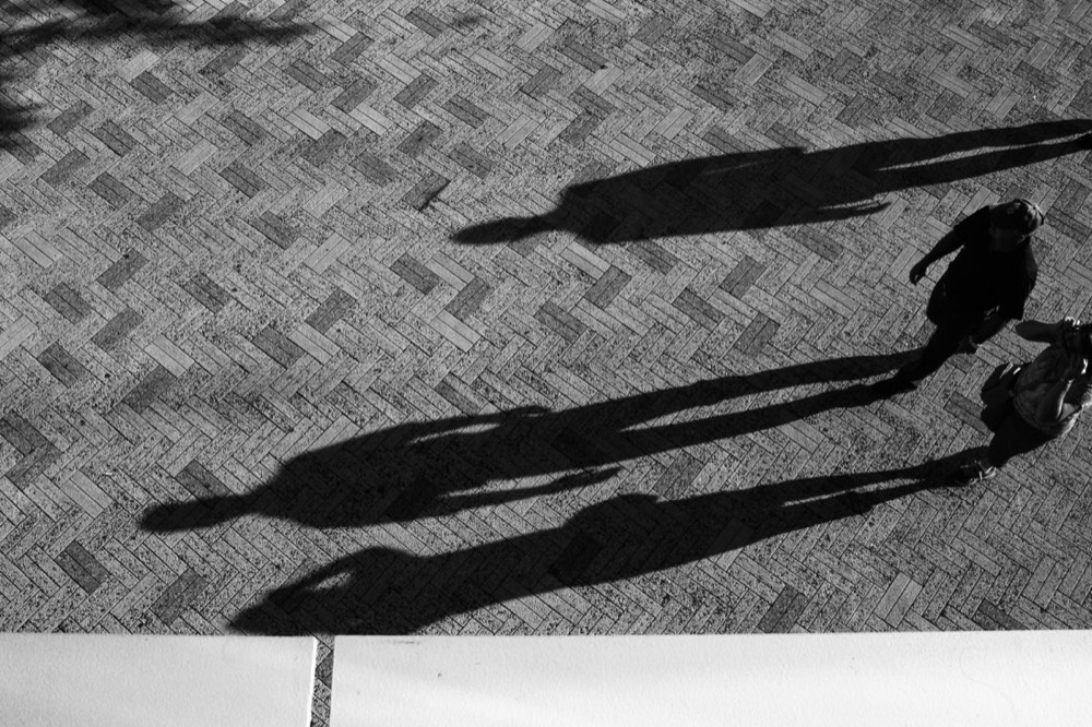 Overhead view of a person's shadow, used for the shadow test to check vitamin D synthesis